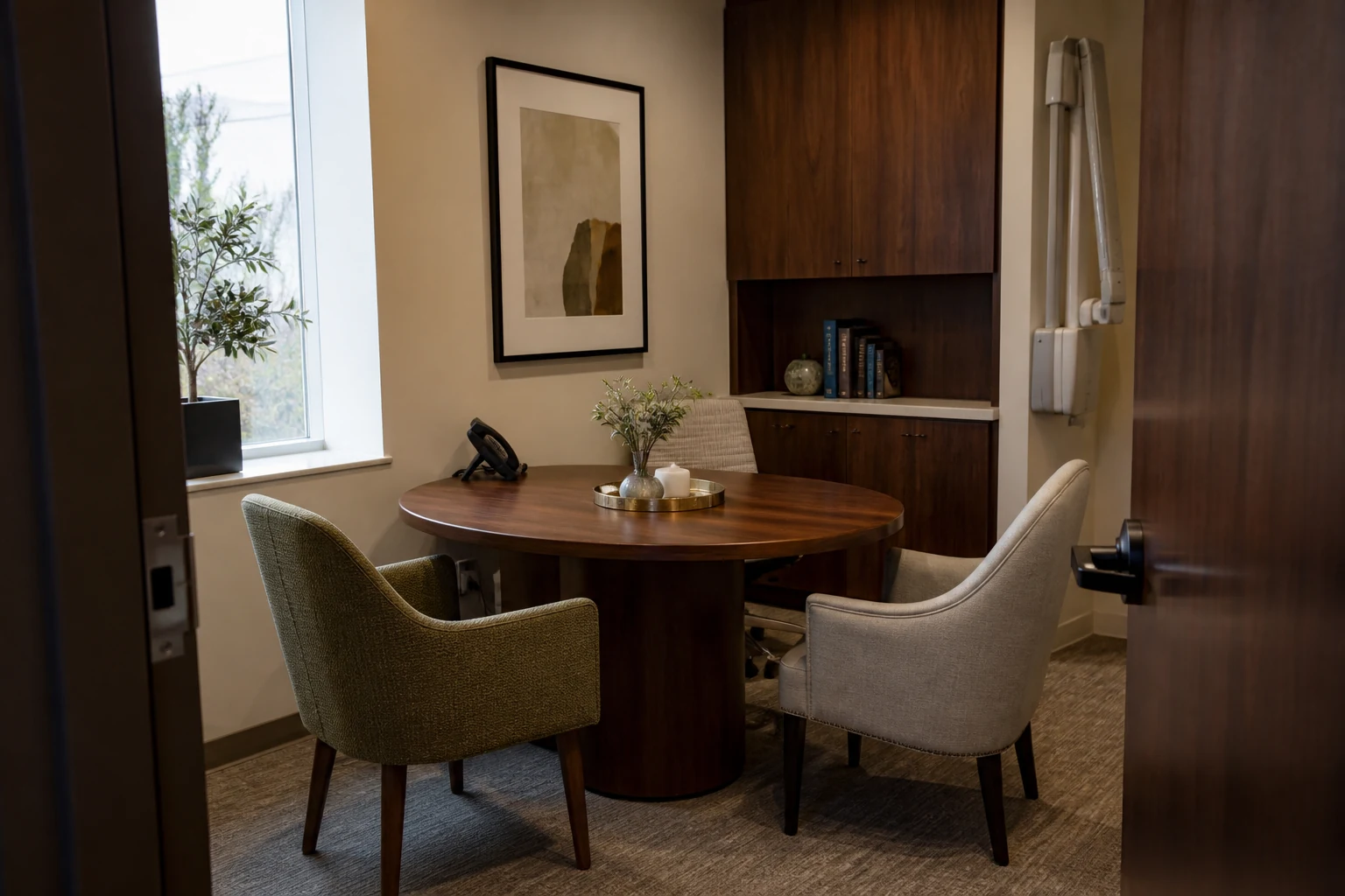Private fictional plastic surgery consultation office with a round table and two guest chairs